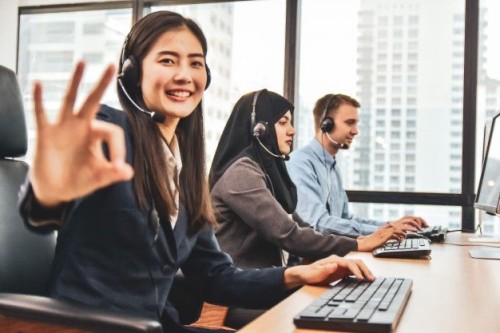 Photo of two people working and answering calls