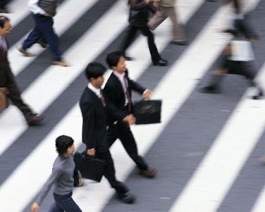 Two businessmen at a pedastrian crossing