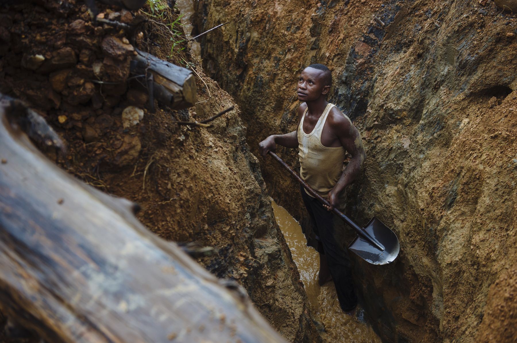 A digger works in a channel cutting through the Mufa II artisanal gold mining site in South Kivu, in the east of the Democratic Republic of the Congo on April 11, 2015. The site is not in an artisanal mining zone, so miners working here are technically doing so illegally.